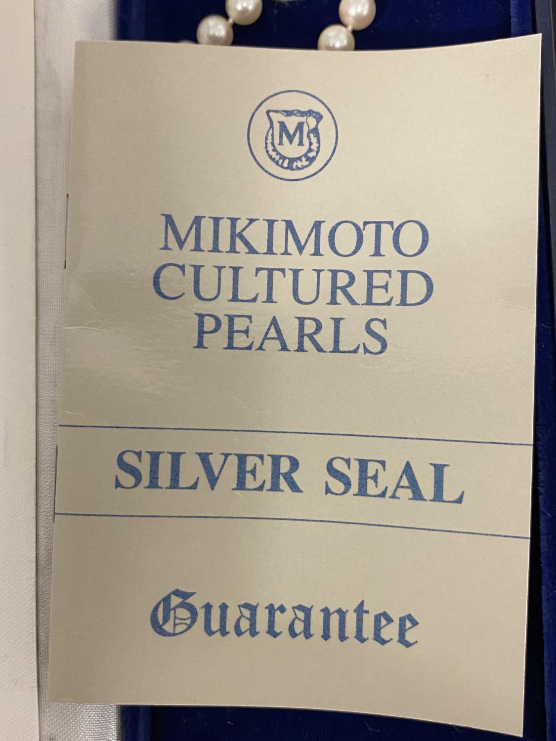 A single strand of cultured uniform pearls by Mikimoto on a 9ct gold clasp with box and certificate, - Image 5 of 5