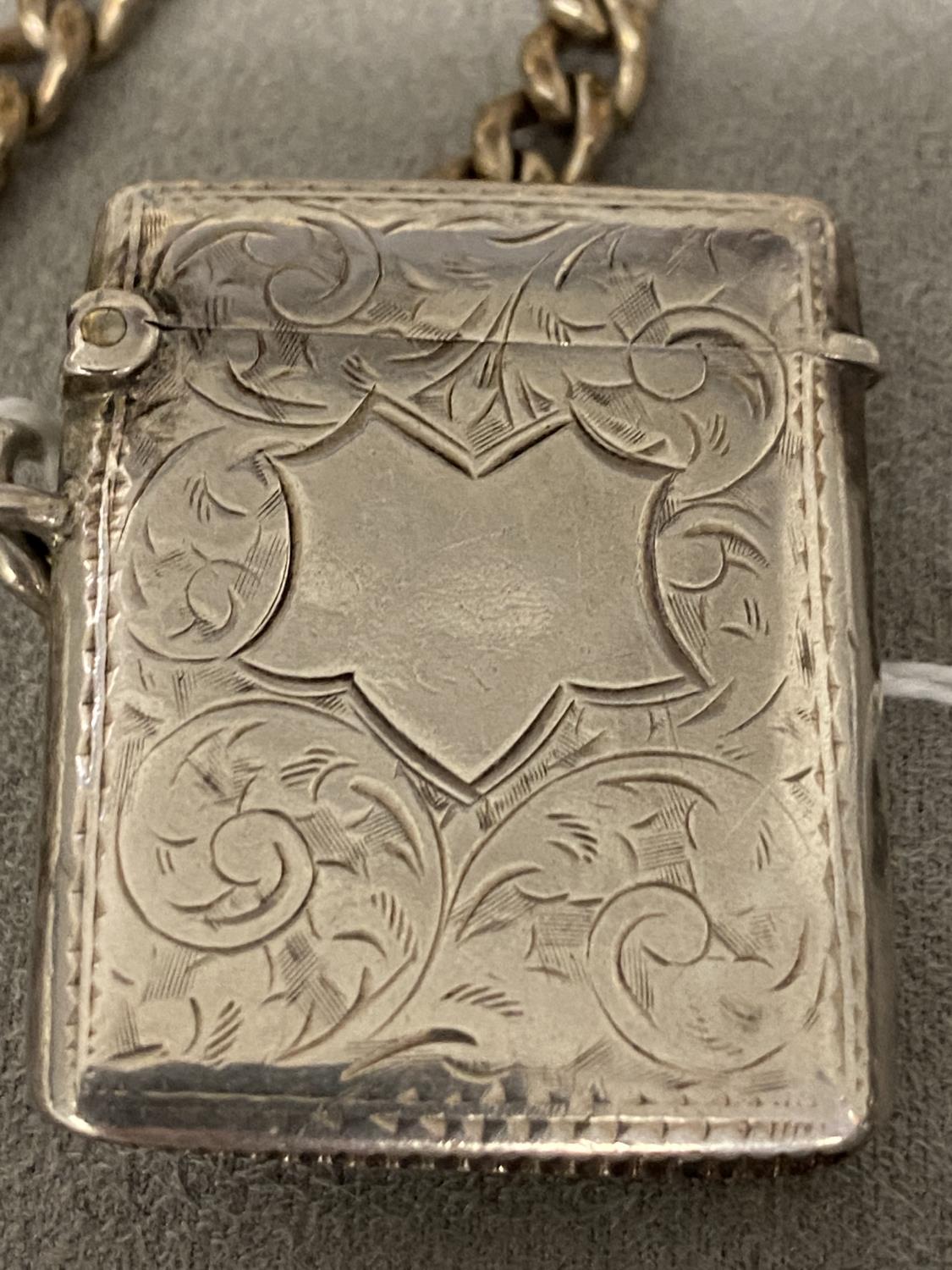 Stirling silver vesta case with chased decoration, Birmingham 1901, white metal curb link chain