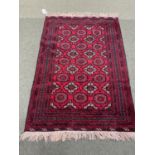 Red and brown oriental rug with brown and red borders, 123 x 175cm