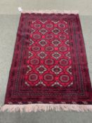 Red and brown oriental rug with brown and red borders, 123 x 175cm