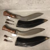 Pair of Indonesian Kukri in leather scabbard, each with 2 additional smaller knives; 47cm long