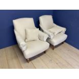 A pair of contemporary arm chairs, "SOFAS & STUFF" upholstered in a cream herringbone fabric,