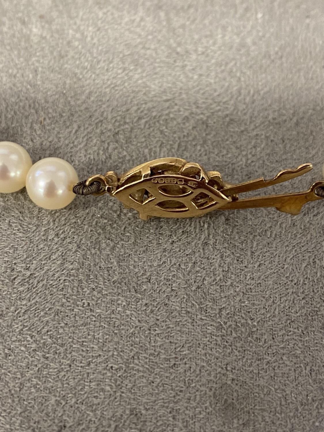A single strand of cultured uniform pearls by Mikimoto on a 9ct gold clasp with box and certificate, - Image 4 of 5