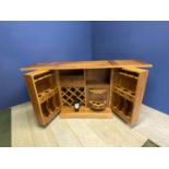 Modern wooden cabinet, opening to reveal a drinks cabinet; on wheels. Vendor purchased it from