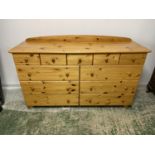 A modern pine chest of 11 drawers, 155cm L x 95cmH