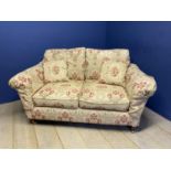 A good quality 2 seater sofa , on mahogany legs to brass castors, upholstered in yellow and red