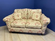 A good quality 2 seater sofa , on mahogany legs to brass castors, upholstered in yellow and red