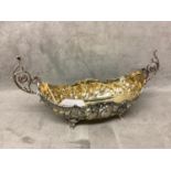 Silver boat shaped dish with scrolling handles chased decoration on 4 feet, marked to base, first