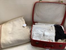Suitcase full of vintage linen, and a bed cover