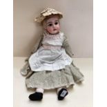 Later C19th/early C20th Continental Bisque headed doll, with open glass eyes glass and mouth, with