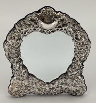 An unmarked white metal easel backed picture frame, shield design with heart shaped aperture, 28 x