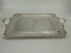 Three silver plated oblong trays with applied loop handles, largest 68 x 41cm