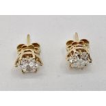 Pair of C18ct gold fancy star cut diamond ear studs approx 8mm diam each, in a 12 claw setting ,