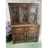 Small oak sideboard, the glazed and lead lined doors, above a 2 drawer and 2 cupboard base