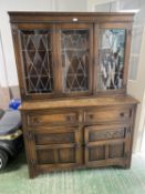 Small oak sideboard, the glazed and lead lined doors, above a 2 drawer and 2 cupboard base