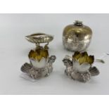 A pair of white metal egg cups in the form of cast chickens with gilt interiors, and a white metal