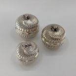 Set of 3 graduated white metal lidded bowls, with reeded decoration flower finials, gilt interior,