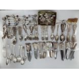 A large collection of plated flatware and kitchen utensils