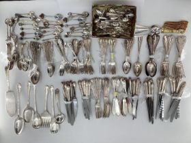A large collection of plated flatware and kitchen utensils