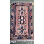 Small oriental rug, pink with blue and cream borders, 126 x 73cm