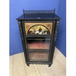 An Aesthetic movement ebonised style single glazed door three shelved cmusic abinet, with spindle