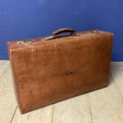 Large leather suitcase and a worn basket ware trunk