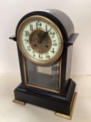 A French, black slate domed top mantel clock, with circular brass dial , (crack to enamel face),