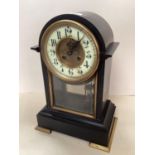 A French, black slate domed top mantel clock, with circular brass dial , (crack to enamel face),