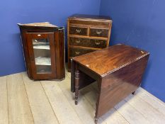 A mahogany drop leaf dining table, a glazed hanging corner cabinet and a chest of 2 short and 3 long