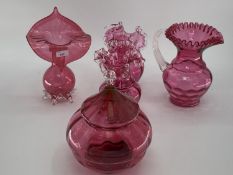 A collection of cranberry glass items to include Jack in a Pulpit vase, lidded bowl, a pair of vases