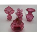 A collection of cranberry glass items to include Jack in a Pulpit vase, lidded bowl, a pair of vases