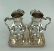 A pair of Christofle white metal water jugs together with a Christofle white metal tray