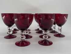 Collection of cranberry glass glasses by Thomas Goode to include 14 white wine, 14 red wine glasses