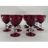 Collection of cranberry glass glasses by Thomas Goode to include 14 white wine, 14 red wine glasses