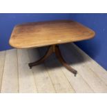 A faded mahogany breakfast table on tripod base swept legs to castors