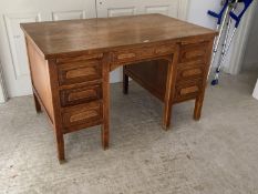 A good early C20th oak desk, single drawer, flanked by slides and three drawers on brass bound feet,
