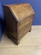 A small George III oak bureau, with four drawers below a fall flap opening to reveal fitted interior