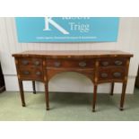 Victorian mahogany serpentine fronted sideboard of 4 drawers, one with dummy handles, and tapered