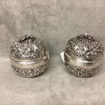 Pair of 900 silver lidded bowls with raised decoration and bird finials, stamped to base 900
