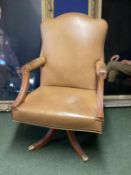 Large winged back light tan and studded brass leather arm chair, on 4 legs to castors