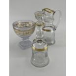 Three gilt glass items to include a C19th Baccarat style decanter and stopper with matching jug, and
