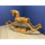 A C20th wooden Rocking horse, Chestnut/light bay, on a sleigh base, with fitted leather saddle