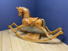 A C20th wooden Rocking horse, Chestnut/light bay, on a sleigh base, with fitted leather saddle