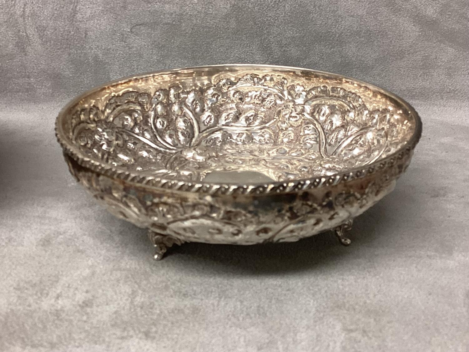 Pair of Middle Eastern white metal bowls with raised floral decoration raised on three feet, 14 x - Image 4 of 5