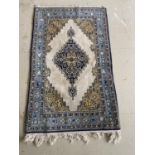 A Qum wool rug, cream and blue ground, 130 x 77cm