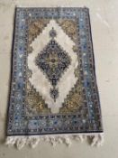 A Qum wool rug, cream and blue ground, 130 x 77cm