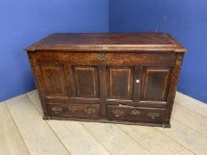 A large 4 pannelled oak mule chest with rising lid and fitted small drawers to interior, and two