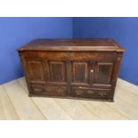 A large 4 pannelled oak mule chest with rising lid and fitted small drawers to interior, and two