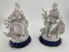 Two C20th bisque figures on blue ceramic bases, unsigned , 35cm H each