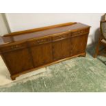 A modern reproduction yew suite of table (with extension), 6 chairs and 2 carvers, and sideboard